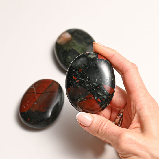 Hand holding Bloodstone Palmstone