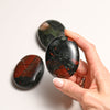 Hand holding Bloodstone Palmstone