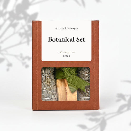 Botanical Set — Reset: terracotta Maison Éthérique box with a window showing white sage, blue sage and Palo Santo tied with green ribbon.