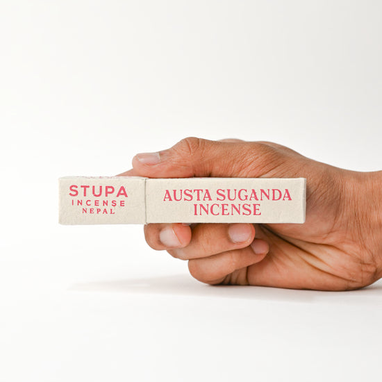 Hand holding Austha Suganda Incense