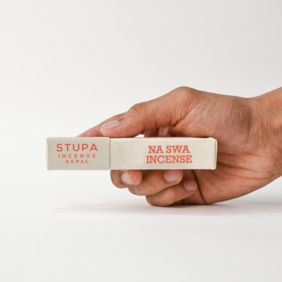 Hand holding Na Swa Incenses sticks Tube