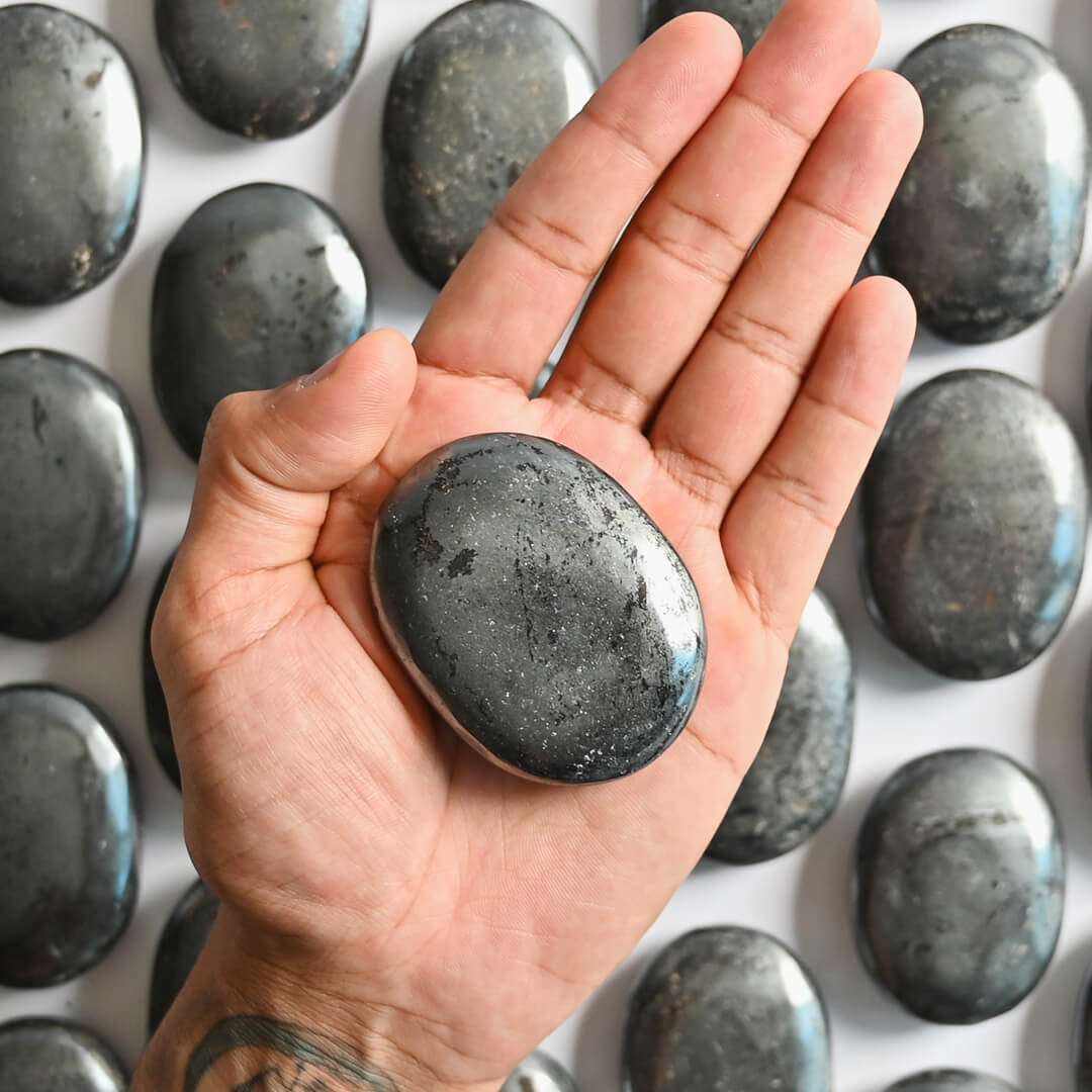 A Hematite Palm Stone on hand