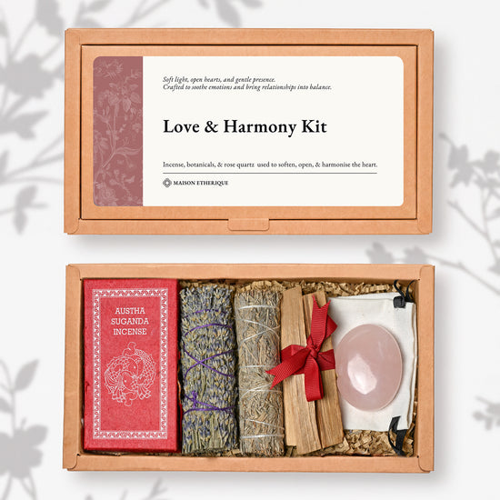 Love and Harmony Kit: kraft box lid above the open box with red Austha Suganda incense, two lavender smudge sticks, Palo Santo and a rose quartz palm stone.