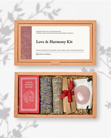 Love and Harmony Kit: kraft box lid above the open box with red Austha Suganda incense, two lavender smudge sticks, Palo Santo and a rose quartz palm stone.