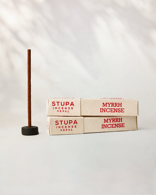 Myrrh incense, tube of 15 sticks: two Stupa paper boxes beside a stick standing in a small holder.