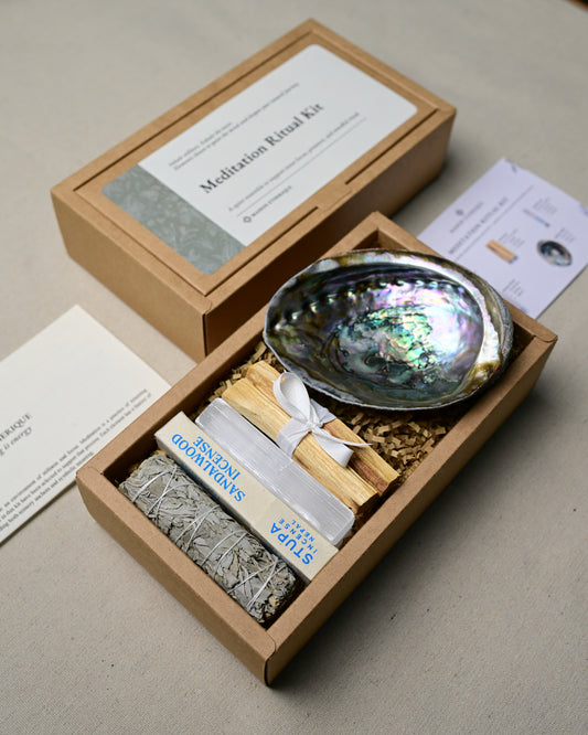 Open Meditation Ritual Kit seen at an angle, showing the abalone shell, Palo Santo, incense box and white sage stick.