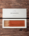 Red Sandalwood incense sticks: Maison Éthérique white box lid above the open box of red-brown sticks, on a wooden surface.
