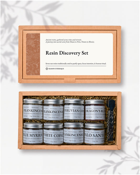 Resin Discovery Kit: kraft box lid above the open box with eight small labelled jars of resin and a pair of metal tongs.