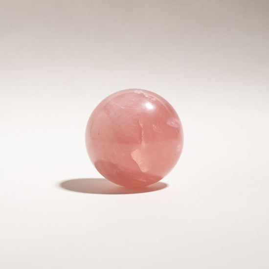  Rose quartz sphere on a white background
