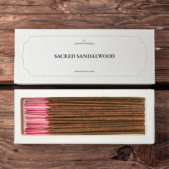Sacred Sandalwood incense sticks from Mysore: Maison Éthérique white box lid above the open box of sticks, on a wooden surface.
