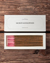 Sacred Sandalwood incense sticks from Mysore: Maison Éthérique white box lid above the open box of sticks, on a wooden surface.