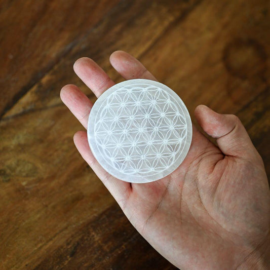 Selenite Plate 8cm round with flower of life in hand