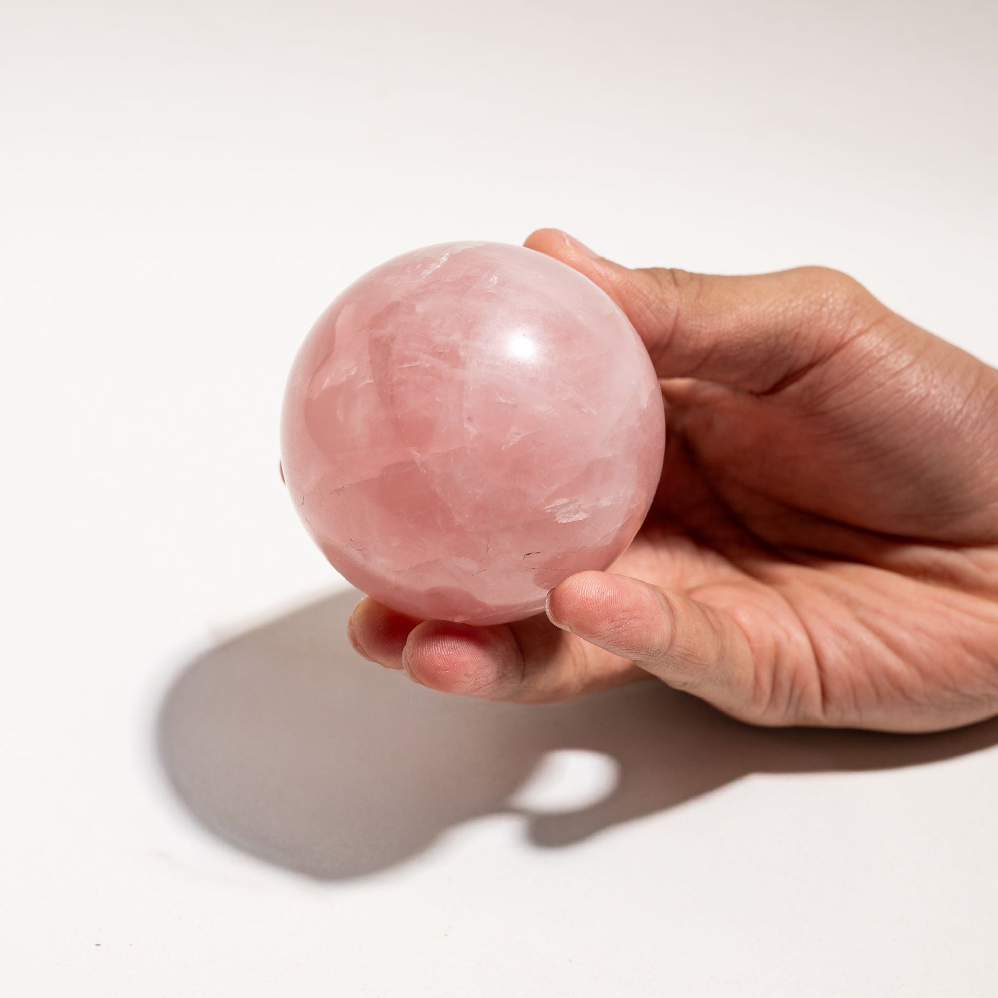 Rose Quartz sphere hand holding 