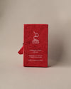 Back of a red paper box of Stupa Austha Suganda incense sticks, handmade in Nepal, on a pale background.