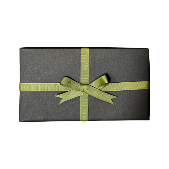 Gift wrapped in dark grey paper and tied with a green ribbon bow, on a black background.