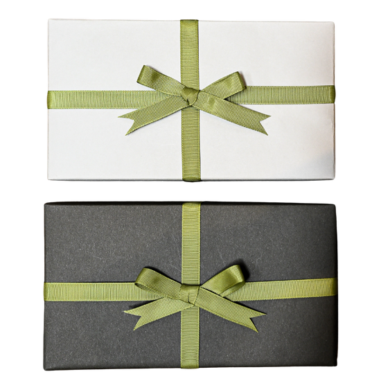 Two wrapped gifts, one in white paper and one in dark grey, each tied with a green ribbon bow, on a black background.