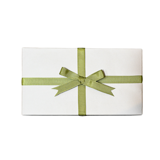 Gift wrapped in white paper and tied with a green ribbon bow, on a black background.