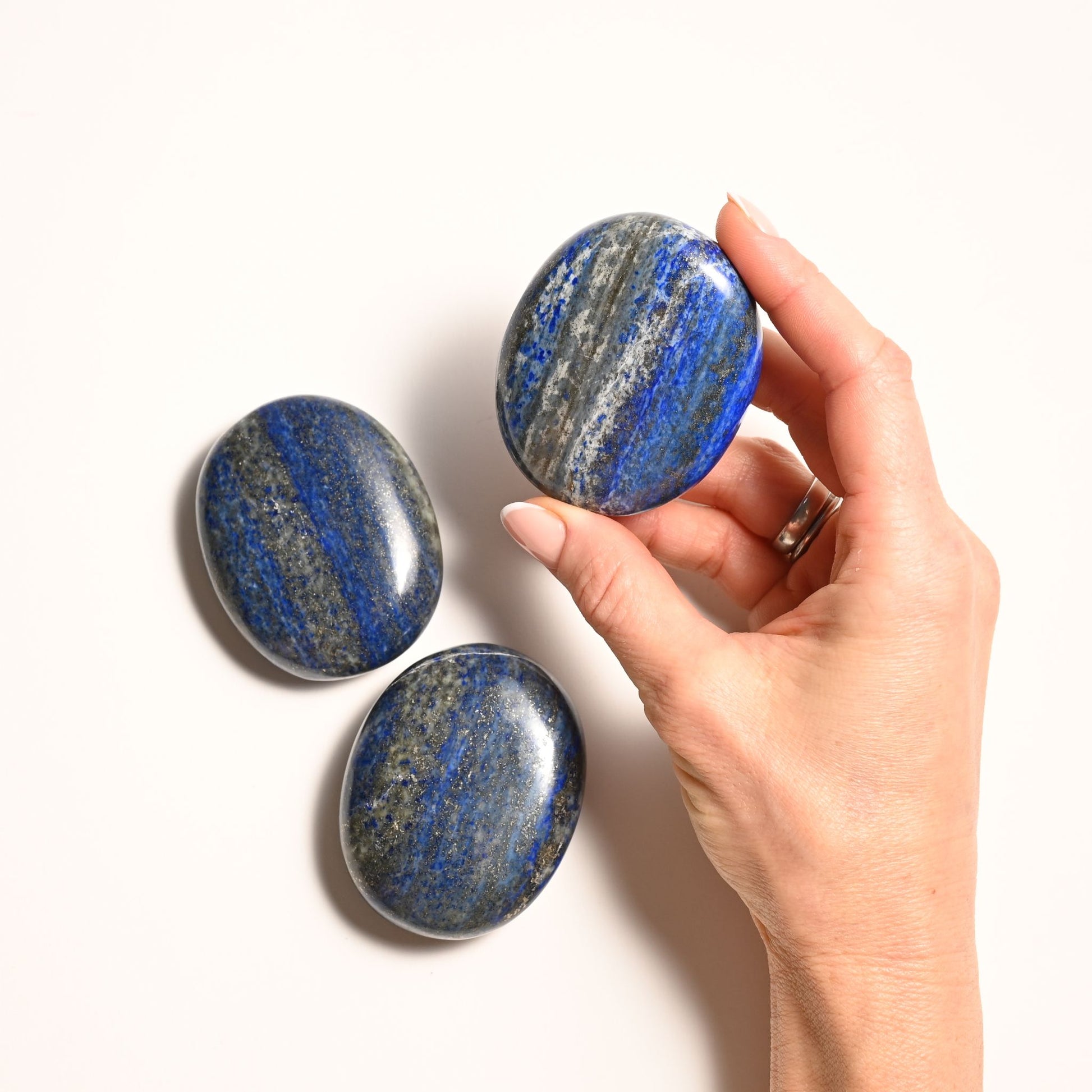 Hands Holding Lapis Lazuli Palm Stone
