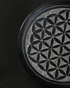 Close view of the Flower of Life pattern carved into the stone incense holder.