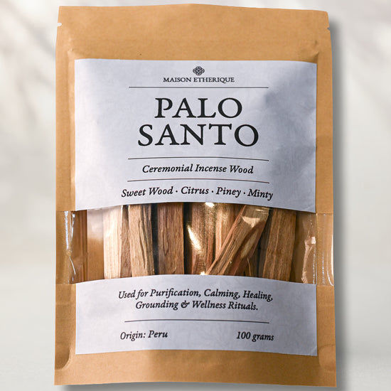 Front of a kraft pouch of Maison Éthérique Palo Santo, 100 g, sticks visible through a clear window, on a pale background.