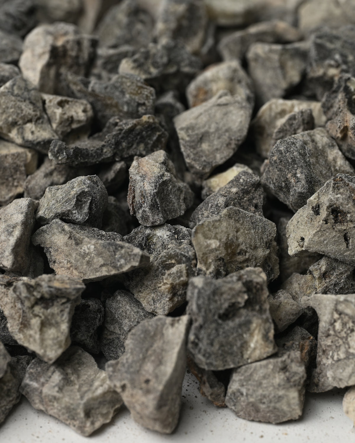 Close view of grey-black Peruvian Black Copal resin pieces (Bursera copallifera).