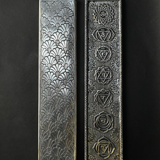 Back and front of the 7 Chakra metal incense stick holder side by side, showing the embossed fan pattern and seven symbols.