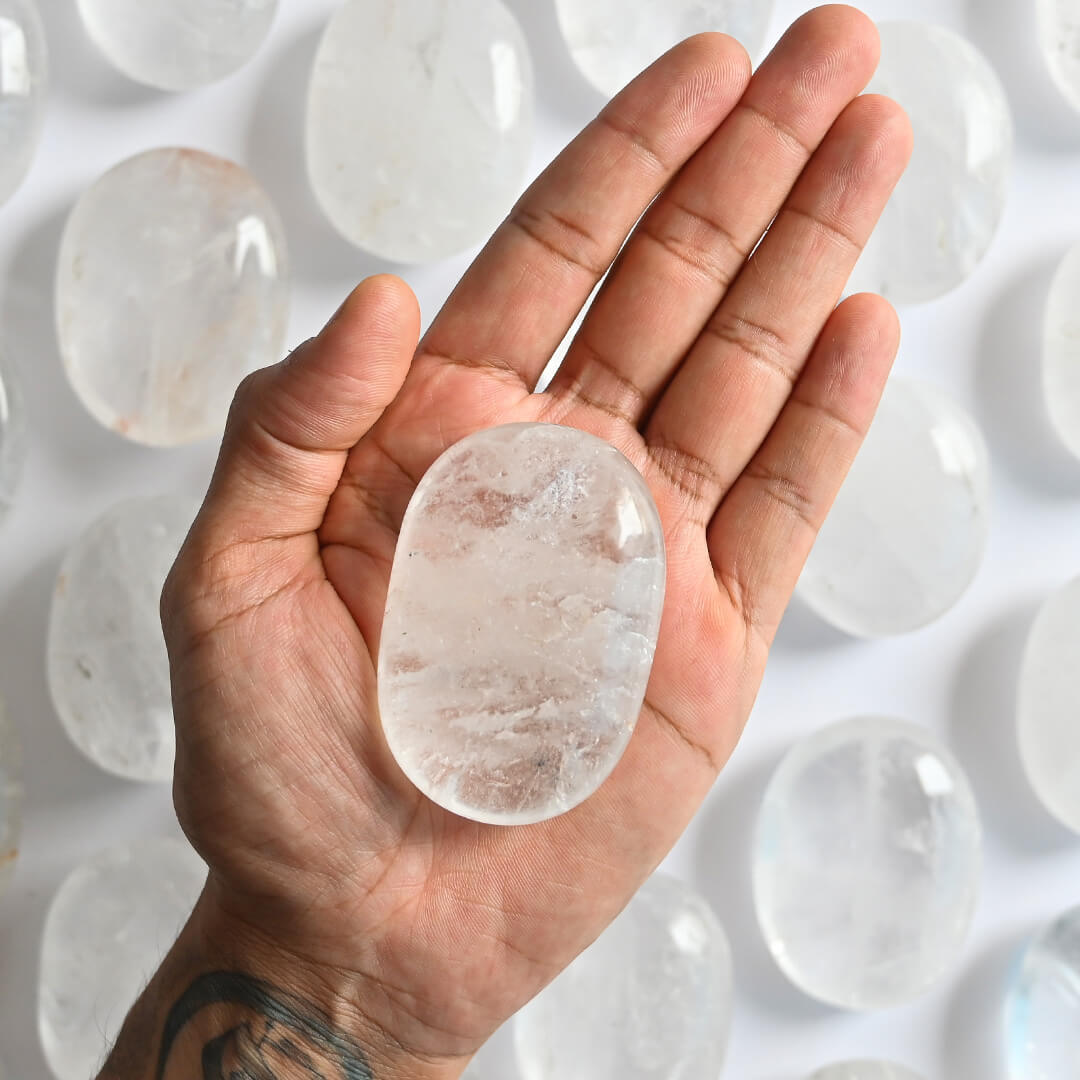 A Clear Quartz palm Stone on hand