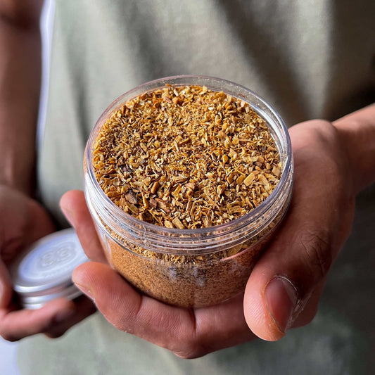 A man showing a jar of Palo Santo Powder 
