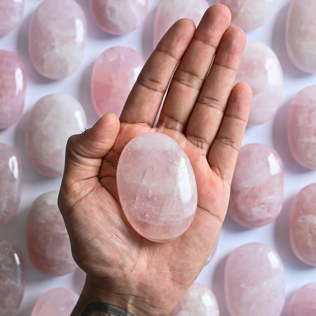 A Rose Quartz Palm Stone in hand